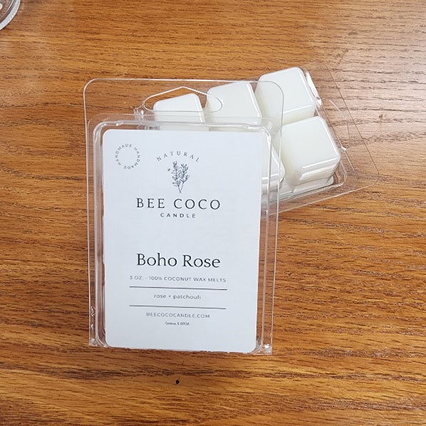 Pack of Bee Coco Candle Boho Rose wax melts on a wooden surface