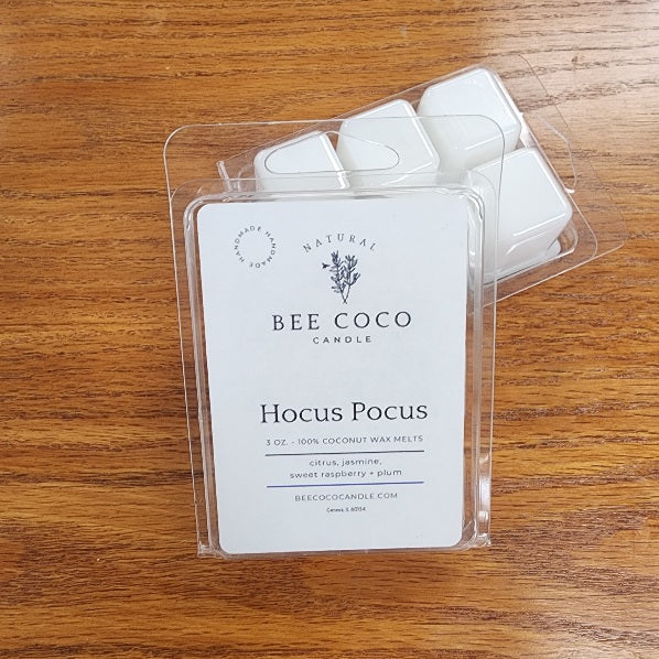 Bee Coco Candle Hocus Pocus wax melts in clear packaging on a wooden surface