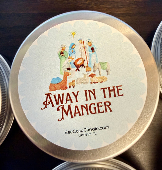 Candle tin lid with 'Away in the Manger' design and branding information.