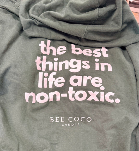 Green hoodie back. "the best things in life are non-toxic" slogan in white