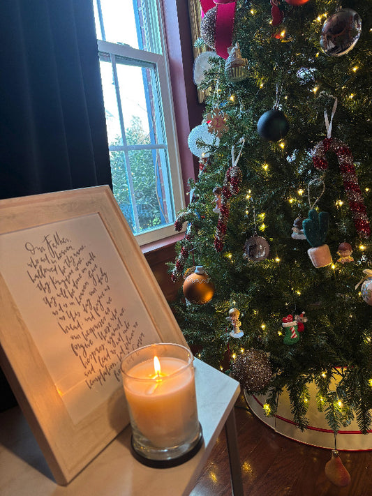 beaituifully lit candle in a Christmas setting