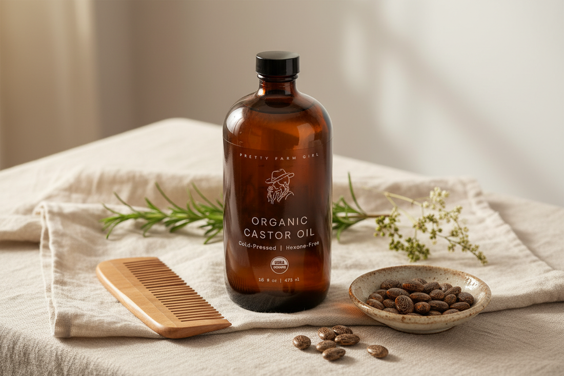 An amber glass castor oil bottle styled with a wooden comb, dried botanicals, and soft linen — clean beauty vibes that match the article's natural wellness angle.