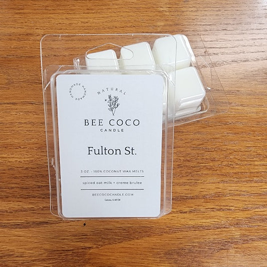 Bee Coco Candle wax melts in packaging on a wooden surface