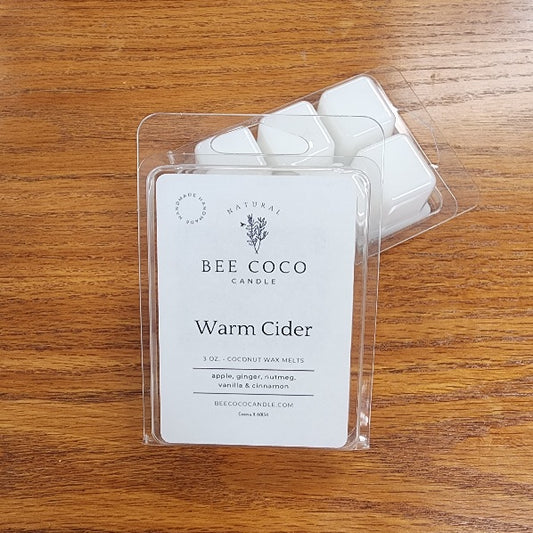 BEE COCO Candle warm cider wax melts in packaging on a wooden surface