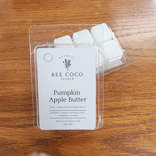 Pack of Bee Coco Pumpkin Apple Butter wax melts on a wooden surface