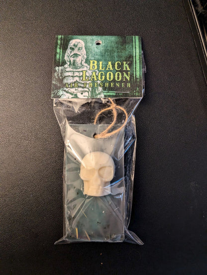 solid air freshener laying in package on black surface