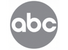 A circular gray logo with the lowercase letters 'abc' in white, centered on a black background.