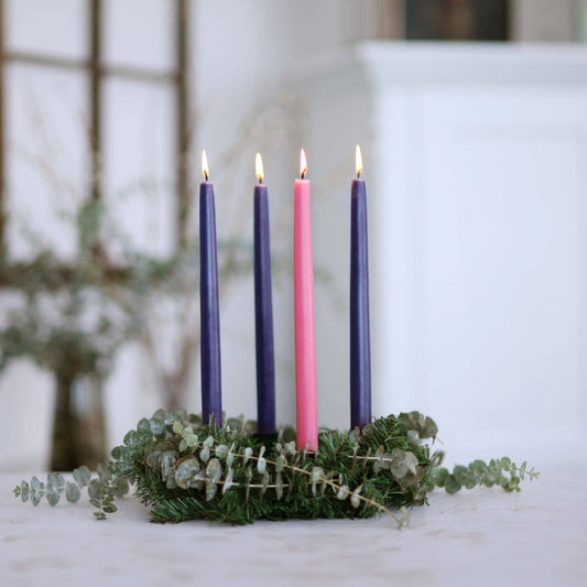 Advent wreath with four candles on a neutral background