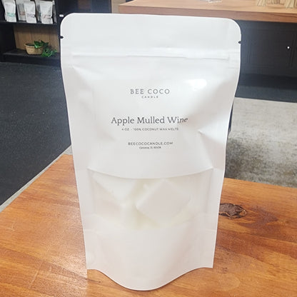 White paper bag with text on a wooden surface