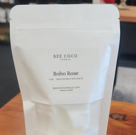 White packaging of Bee Coco Boho Rose coconut wax melts on a wooden surface.