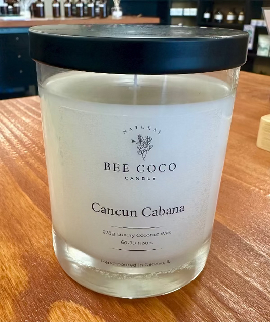 Bee Coco candle labeled 'Cancun Cabana' on a wooden surface