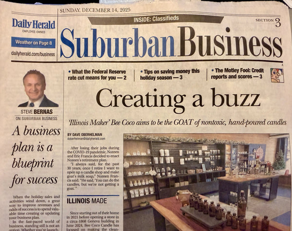 A newspaper front page from the Daily Herald, featuring the headline 'Suburban Business' and a large article titled 'Creating a buzz.' The page includes a photo of a candle display inside a shop, with a small portrait of Steve Bernas and several news teasers around the masthead.