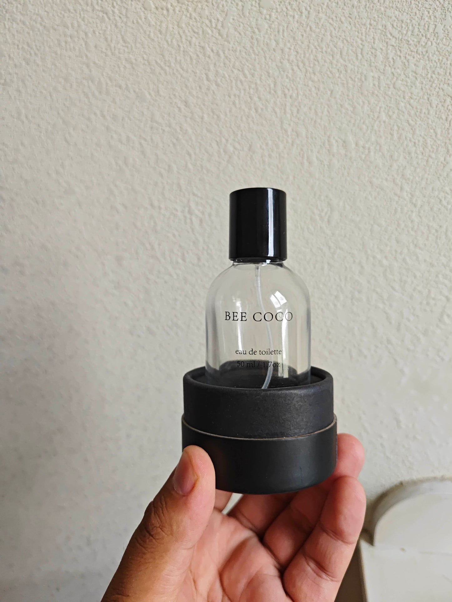 Bee Coco eau de toilette Box and bottle in mans hand