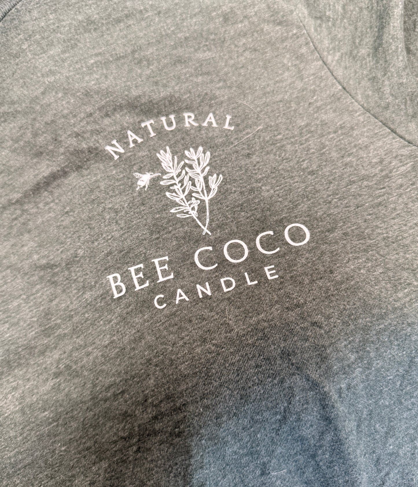 heathered green tee with 'Bee Coco Candle' logo printed on front chest pocket area