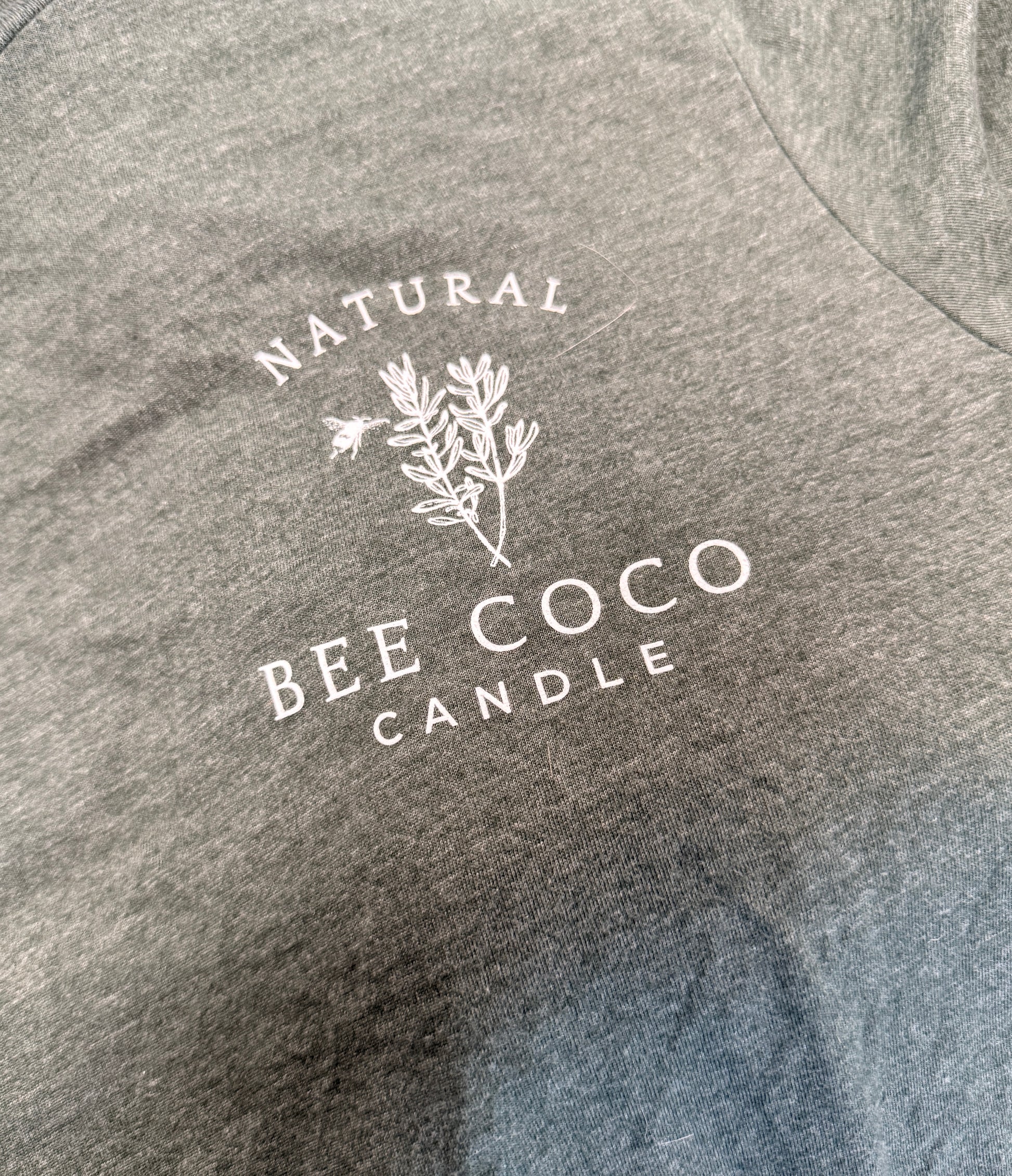 heathered green tee with 'Bee Coco Candle' logo printed on front chest pocket area