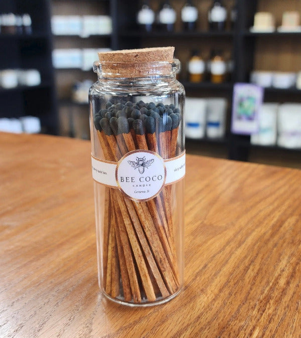 Jar of matches with a visible label on a wooden surface