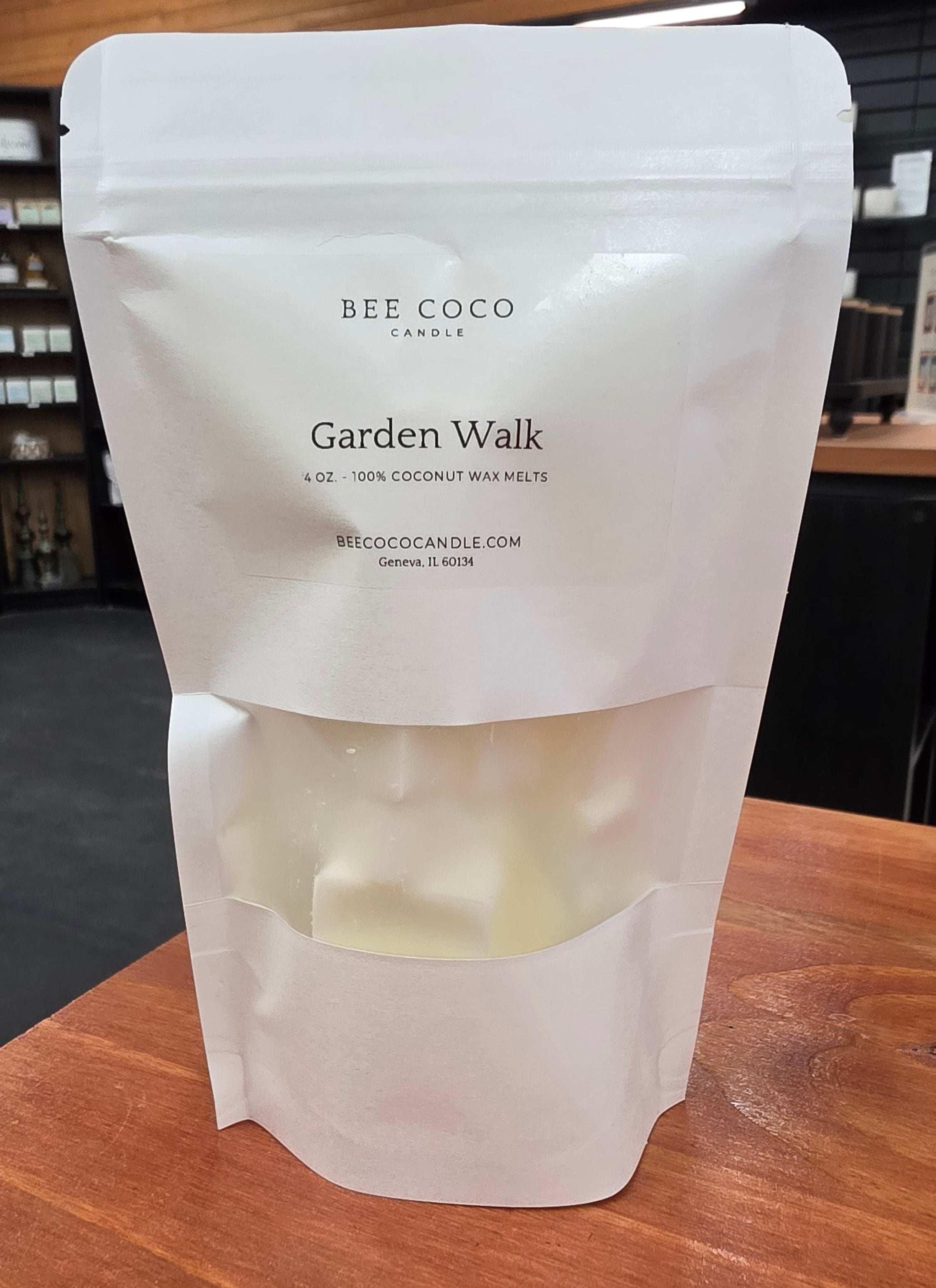Bee Coco Candle Garden Walk wax melt bag on a wooden surface