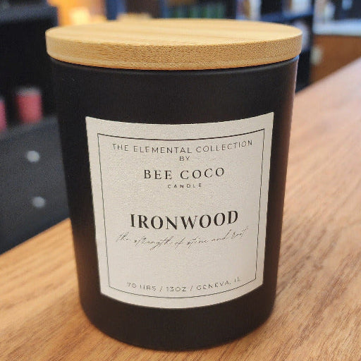 Non toxic candle labeled 'Ironwood' on a wooden surface with a blurred background
