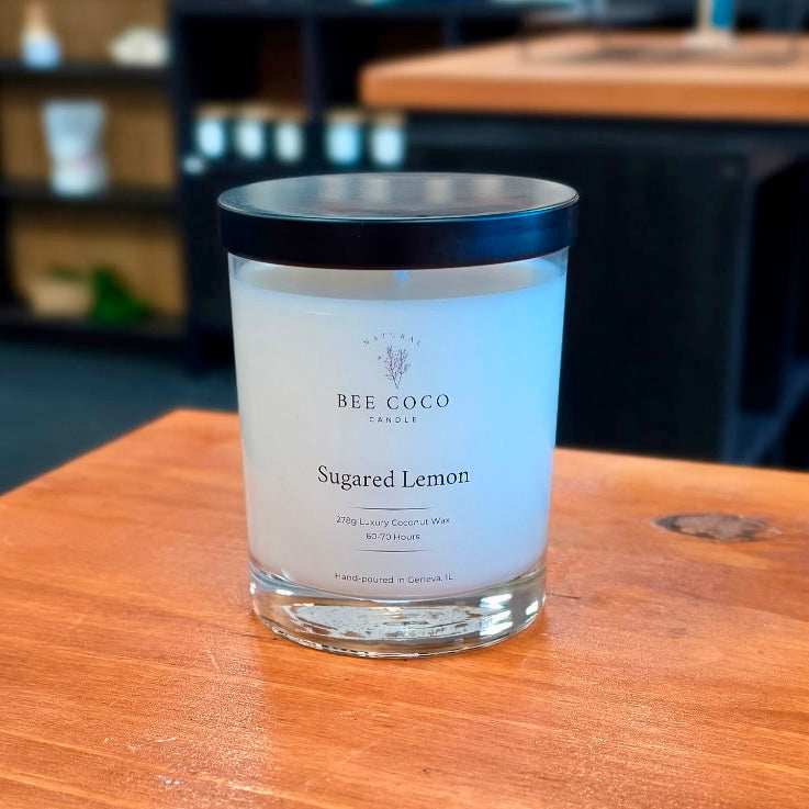 Sugared Lemon Candle sitting on wood countertop