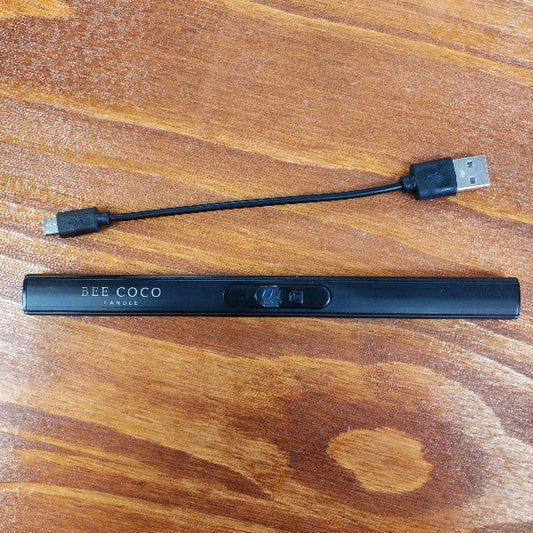 Black electronic device with USB cable on a wooden surface