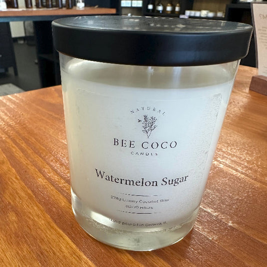 Bee Coco Watermelon Sugar candle on a wooden surface