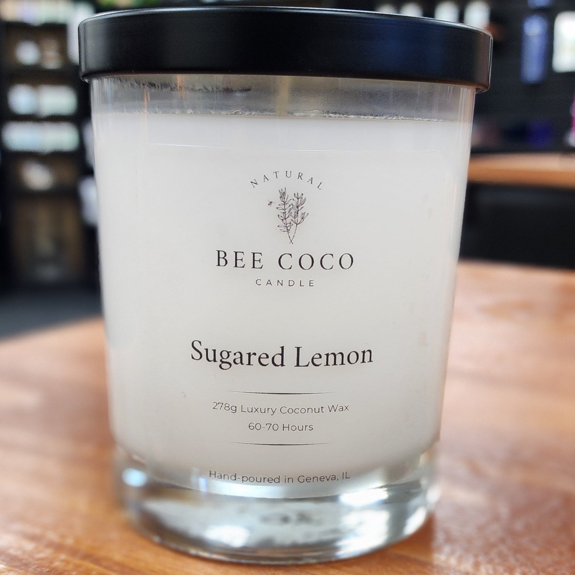 Bee & Coco Sugared Lemon candle on a wooden surface