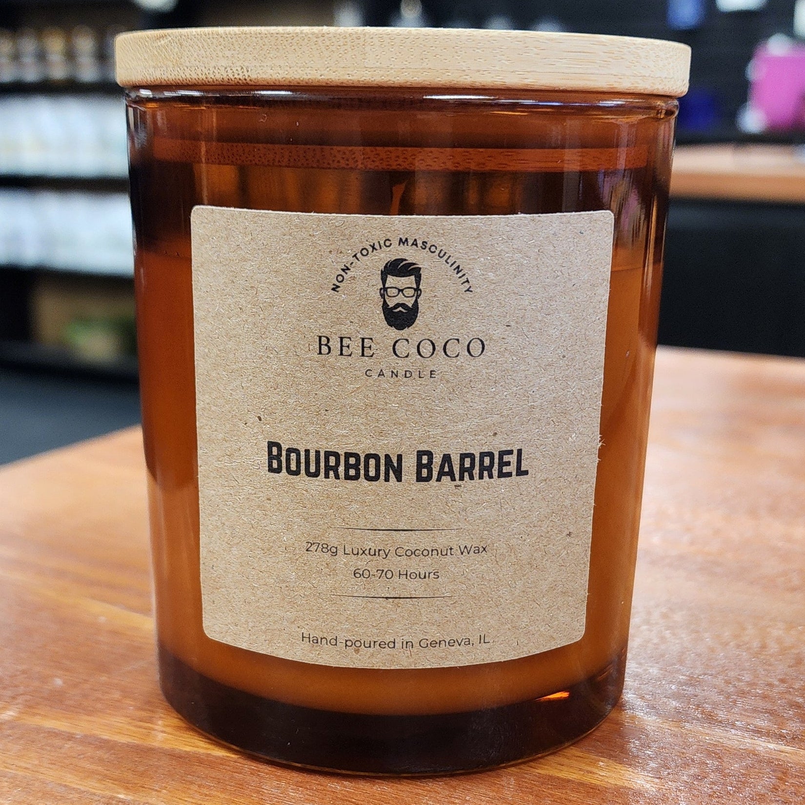 Bourbon Barrel-aged candle on a wooden surface with blurred background