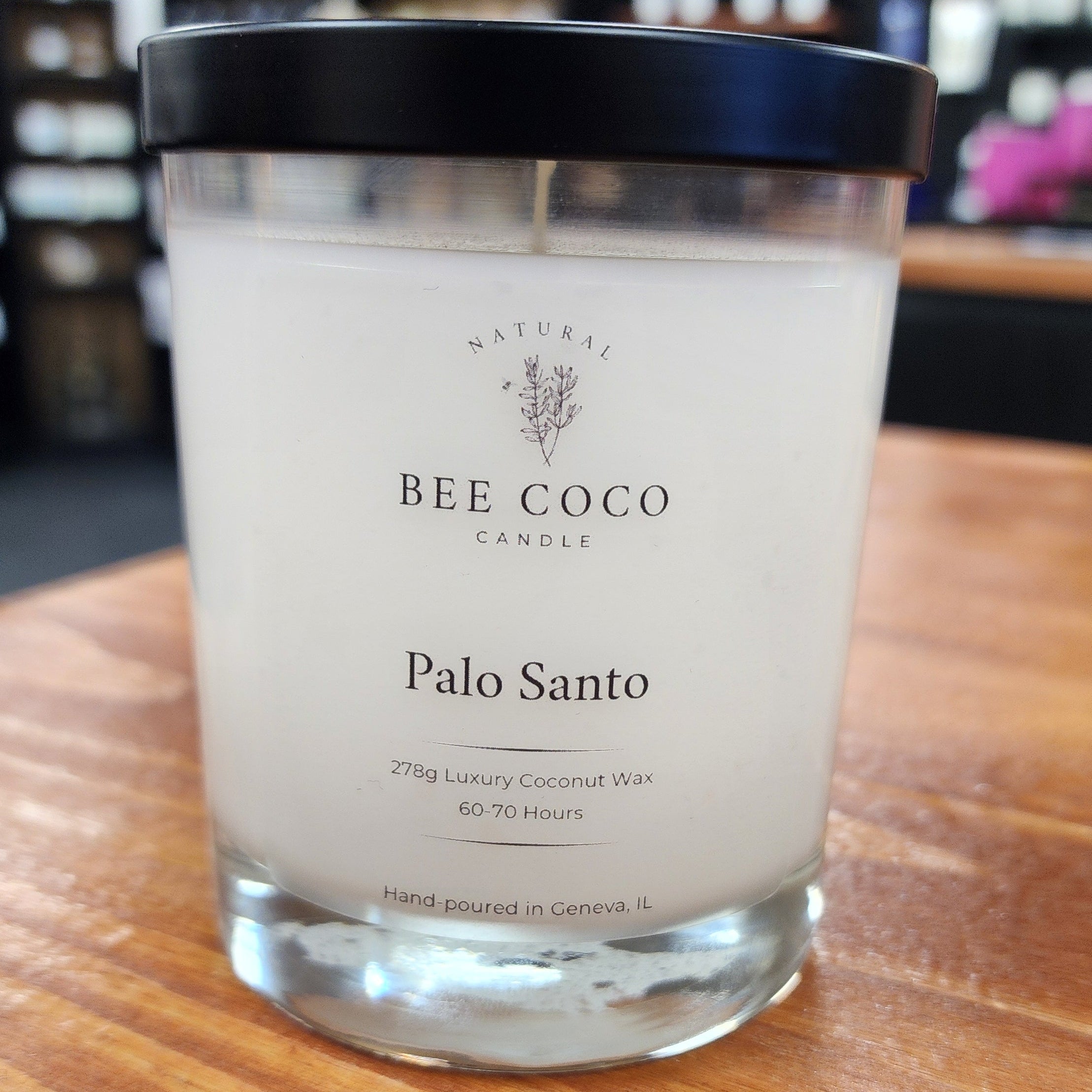 Bee Coco Palo Santo candle on a wooden surface